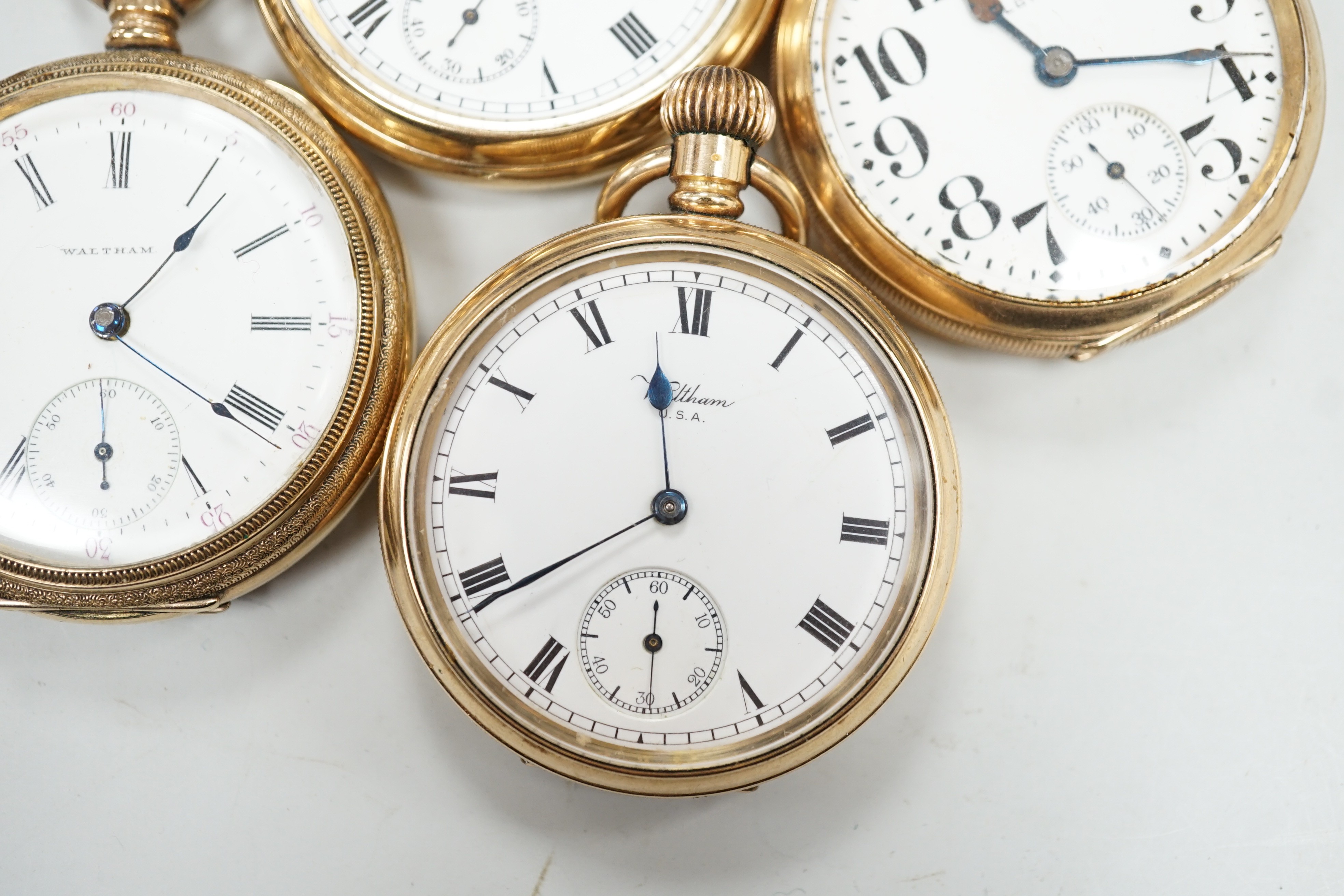 Three assorted gold plated Waltham open faced pocket watches and a similar Elgin pocket watch.